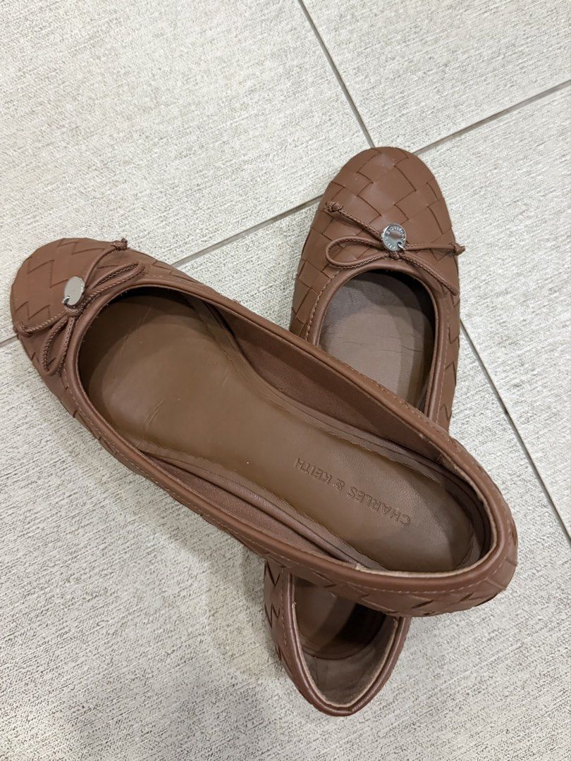 Charles & Keith Brown Ivette Woven Flats (Category: Flats & Sandals) located in Davao. Submitted by pamdyclutters (Listing ID 1470059771, Image 2). Description: - Brand: Charles & Keith - Size: 37 - Color: Brown - Style: Slip-on flats with woven texture - Accents: Tiny front bow and metallic button - Condition: Outer material is intact, soles show minor dirt from previous wear.