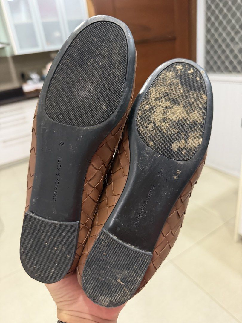 Charles & Keith Brown Ivette Woven Flats (Category: Flats & Sandals) located in Davao. Submitted by pamdyclutters (Listing ID 1470059771, Image 3). Description: - Brand: Charles & Keith - Size: 37 - Color: Brown - Style: Slip-on flats with woven texture - Accents: Tiny front bow and metallic button - Condition: Outer material is intact, soles show minor dirt from previous wear.