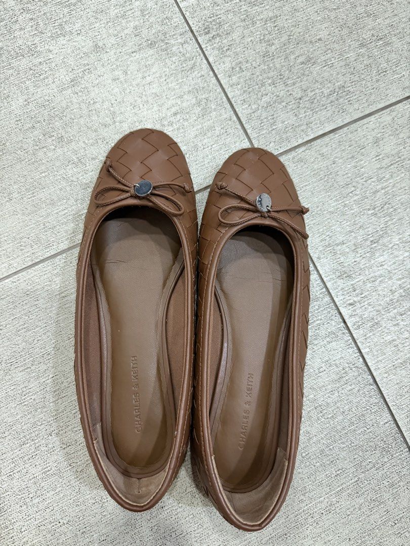 Charles & Keith Brown Ivette Woven Flats (Category: Flats & Sandals) located in Davao. Submitted by pamdyclutters (Listing ID 1470059771, Image 1). Description: - Brand: Charles & Keith - Size: 37 - Color: Brown - Style: Slip-on flats with woven texture - Accents: Tiny front bow and metallic button - Condition: Outer material is intact, soles show minor dirt from previous wear.