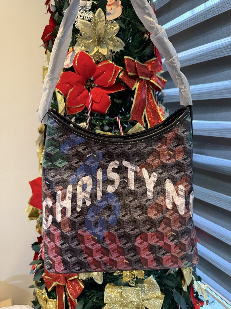 Christy Ng Alesso Medium (Category: Shoulder Bags) located in Manila. Submitted by maryjoremf13085 (Listing ID 1470002892, Image 3). Description: - Condition: Brand new, unused with handle protective wrappings intact - Design: Stylish geometric print with contrast black trim on top and base - Features: Secure top zipper closure and structured base panel to keep the bag upright - Variants: 3 options available, including one with bold 'Christy' whi