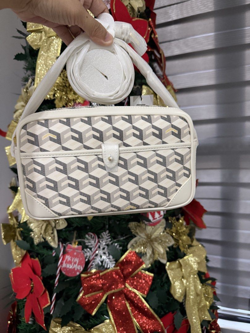 Christy Ng Pedro (Category: Cross-body Bags) located in Manila. Submitted by maryjoremf13085 (Listing ID 1470003819, Image 3). Description: - Brand: Christy Ng - Style: Geometric pattern crossbody bag - Colors available: Burgundy and white - Features: Front flap pocket and gold-tone logo lettering - Includes: Matching strap - Condition: Brand new with tags attached, original wrapping intact on hardware and straps.