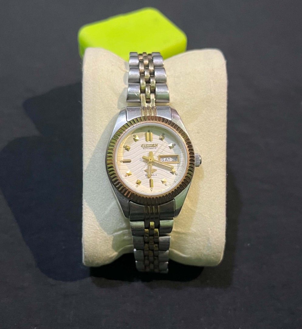 Citizen Automatic Two-Tone Ladies Watch (Category: Women's Watches) located in Cebu City. Submitted by jbok_watches. (Listing ID 1470103179, Image 1). Description: - Brand: Citizen Automatic Watch - Dial: Textured white with gold-tone hour markers & day-date window at 3 o'clock - Bezel: Fluted design in gold-tone - Bracelet: Two-tone steel and gold jubilee bracelet with signed folding clasp - Caseback: Stainless steel with engraved model text - C