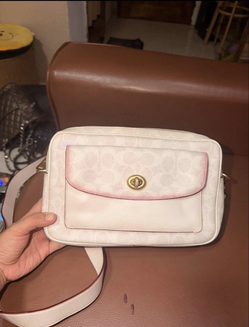 Coach Signature Monogram (Category: Luxury Bags & Wallets) located in Mati. Submitted by thriftedbagsbeyond (Listing ID 1469966473, Image 3). Description: This is a Coach Signature (monogram) canvas crossbody bag with a front flap and gold turn-lock closure, in a white/cream (or chalk/ivory) colorway. Key details from the photos: • Signature coated canvas with the classic repeating “C” monogram pattern in a light/off-white tone. • Front flap (als
