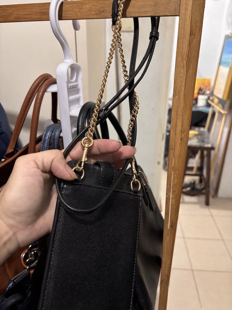 Coach Black Leather Phone Crossbody Bag (Category: Cross-body Bags) located in Quezon City. Submitted by warmfalcon_3ce574 (Listing ID 1470096009, Image 1). Description: - Brand: Coach - Color: Classic Black - Material: Premium textured leather - Hardware: Elegant gold-tone accents with stylish chain details - Pockets: Front flap pocket with snap closure and a secure zip pocket - Strap: Detachable strap for versatile styling - Size: Compact and p