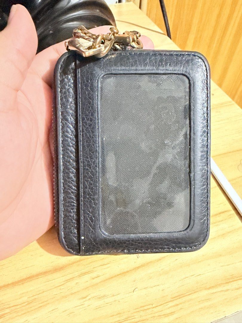 Coach Black Leather Zip Card Holder with Chain (Category: Luxury Bags & Wallets) located in Quezon City. Submitted by cavp_ (Listing ID 1470094238, Image 2). Description: Authentic coach (bought from US. Padala po ng mom ko) well used, as seen on photos. may tarnish na po ang hardware and yung leather niya medyo flat na po siya like di na ganun ka feel ang grain ng leather due to use but no major flaws. Still very much usable po sa hindi po sa hi