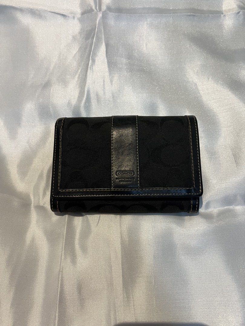 Coach Black Signature C Canvas Leather Medium Wallet (Category: Luxury Bags & Wallets) located in Manila. Submitted by ghengdhoze (Listing ID 1470059135, Image 1). Description: - Brand: Coach - Color: Black (Signature C canvas with black leather trim) - Hardware: Silver-tone - Closure: Snap button strap - Interior: Multiple card slots, bill compartment, and zippered coin pocket - Size: Compact, fits easily into any handbag - Condition: Clean inte