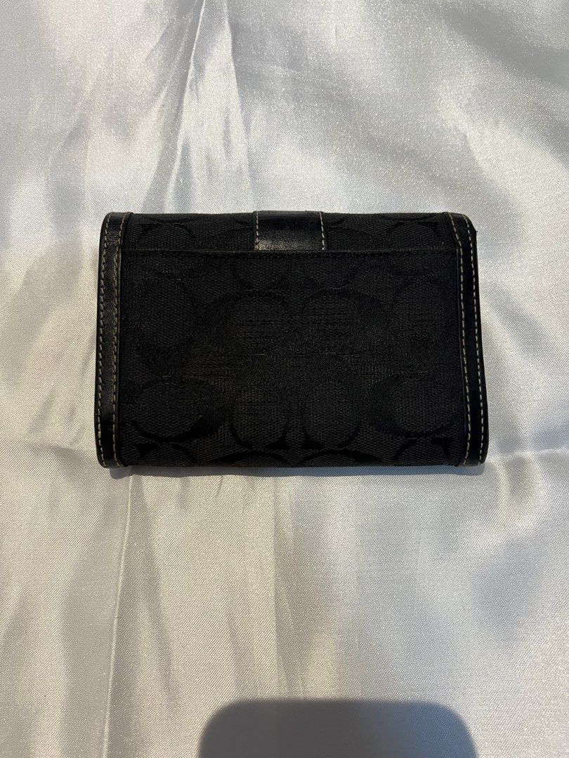 Coach Black Signature C Canvas Leather Medium Wallet (Category: Luxury Bags & Wallets) located in Manila. Submitted by ghengdhoze (Listing ID 1470059135, Image 2). Description: - Brand: Coach - Color: Black (Signature C canvas with black leather trim) - Hardware: Silver-tone - Closure: Snap button strap - Interior: Multiple card slots, bill compartment, and zippered coin pocket - Size: Compact, fits easily into any handbag - Condition: Clean inte