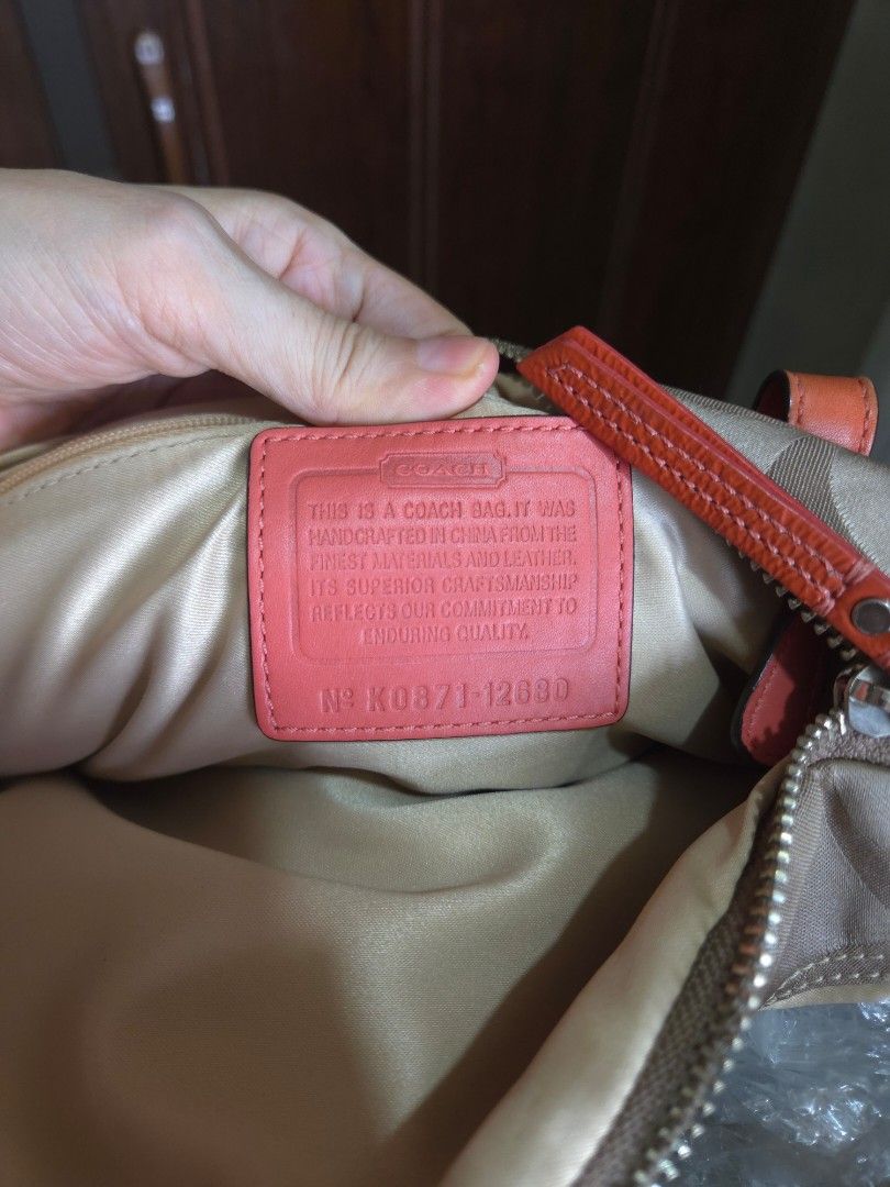 Coach Bonnie Satchel bag (Category: Luxury Bags & Wallets) located in Manila. Submitted by vanch0304 (Listing ID 1470093058, Image 3). Description: Authentic Coach shoulder bag in beige signature C jacquard with vibrant orange leather trim and dual top handles. Features two zipper compartments, an orange leather hangtag, a decorative flower charm, and a clean interior with the official creed patch. Perfect pop of color for your everyday outfit! e