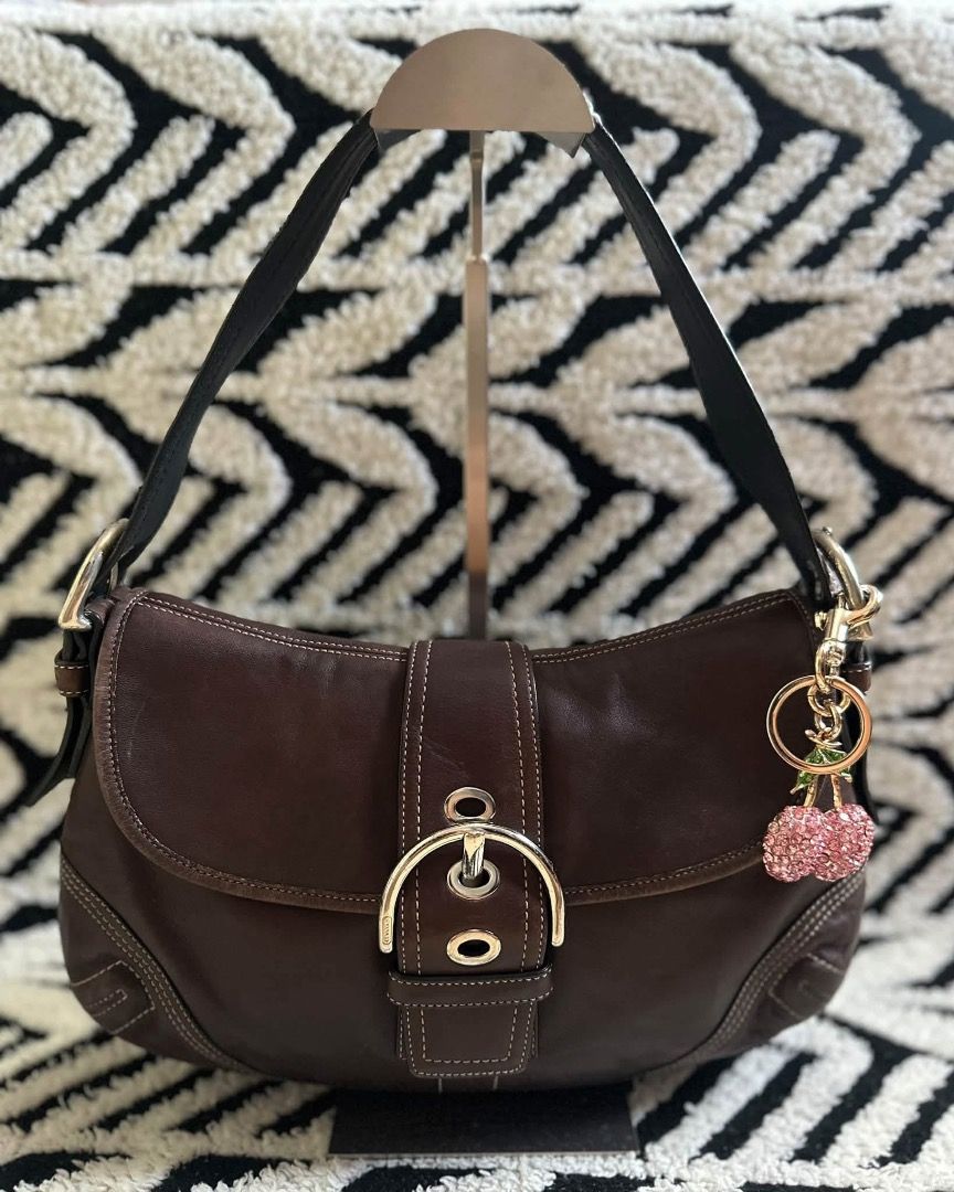 Coach Brown Leather Shoulder Bag (Category: Luxury Bags & Wallets) located in Cebu City. Submitted by isellhere123.543 (Listing ID 1469984128, Image 1). Description: - Authentic Coach shoulder bag in rich brown full-grain leather - Secure magnetic snap closure beneath the front buckle strap - Comfortable adjustable buckle handle - Clean brown fabric interior with creed patch numbered F10192 - Maintains a structured shape with minor natural grain 