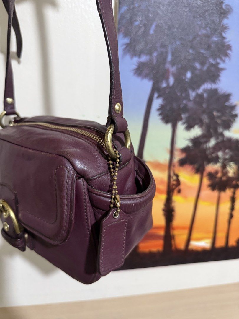 Coach Campbell Leather Camera Crossbody Bag (Category: Cross-body Bags) located in Quezon City. Submitted by vianca13 (Listing ID 1470034975, Image 3). Description: - Authentic Coach leather shoulder bag in a stunning rich purple - Compact camera bag silhouette with chic gold-tone hardware - Convenient front flap pocket featuring a stylish buckled strap detail - Secure zip-top closure opening to a clean fabric lining with inner creed patch - Comp