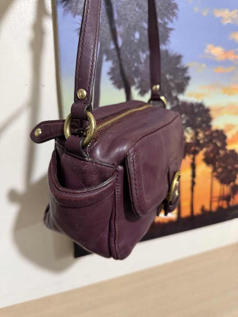 Coach Campbell Leather Camera Crossbody Bag (Category: Cross-body Bags) located in Quezon City. Submitted by vianca13 (Listing ID 1470034975, Image 2). Description: - Authentic Coach leather shoulder bag in a stunning rich purple - Compact camera bag silhouette with chic gold-tone hardware - Convenient front flap pocket featuring a stylish buckled strap detail - Secure zip-top closure opening to a clean fabric lining with inner creed patch - Comp