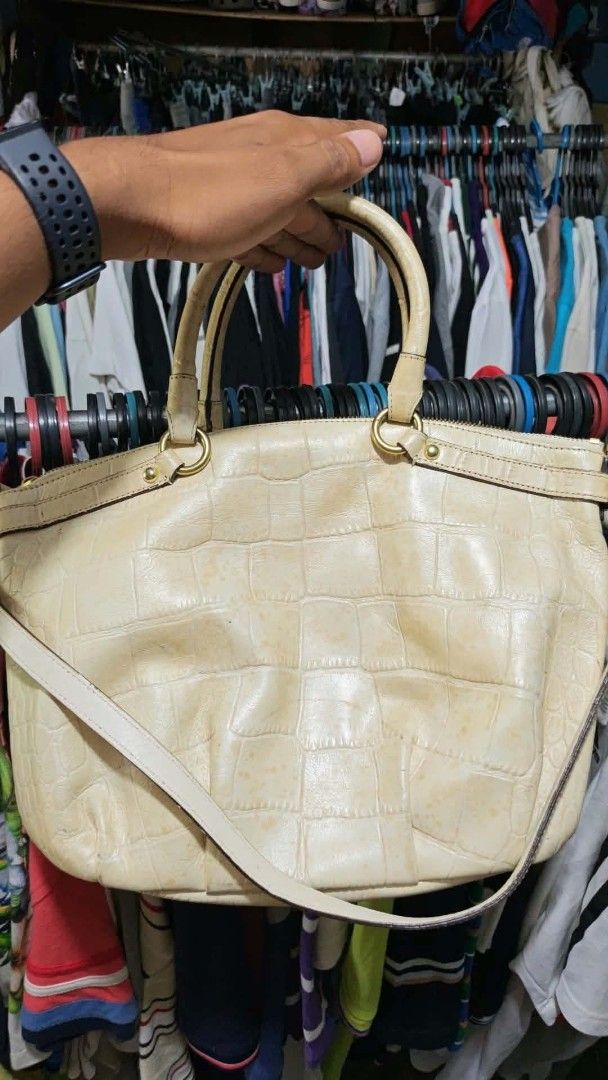 Coach Crocodile Embossed Leather Handbag Cream (Category: Luxury Bags & Wallets) located in Isulan. Submitted by jaysthrift (Listing ID 1470027602, Image 2). Description: - Brand: Coach - Color: Cream with light pink interior - Material: Crocodile embossed leather - Hardware: Gold-tone - Closure: Zip top - Strap: Dual top handles and detachable crossbody strap - Interior: Fabric lining with slip pockets and Coach leather creed patch (Serial: A137