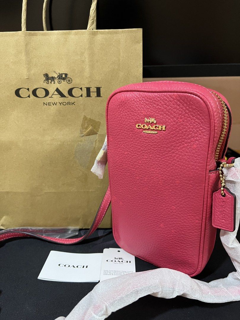 Coach Eva Phone Crossbody Bag (Category: Cross-body Bags) located in Santa Rosa. Submitted by ninaparis (Listing ID 1470138163, Image 1). Description: Original Coach Eva Phone Crossbody in vibrant Hot Pink Pebbled Leather with Gold Tone Hardware.
