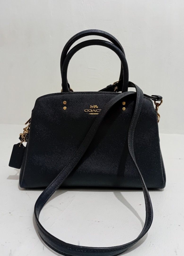 Coach handbag/ Crossbody (Category: Luxury Bags & Wallets) located in Manila. Submitted by eriiicaspage (Listing ID 1469959577, Image 1). Description: PreOwned LikeNew Lightly Used Authentic b Coach structured handbag in durable crosshatch Saffiano leather Color Navy blue - Elegant gold-tone hardware, including bottom protective feet and front logo stamp - Secure zip-top closure with a matching leather hangtag - Sturdy double top handles for comf