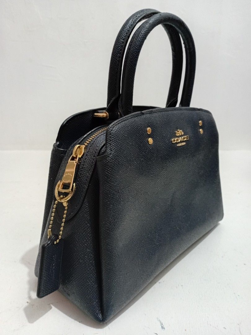 Coach handbag/ Crossbody (Category: Luxury Bags & Wallets) located in Manila. Submitted by eriiicaspage (Listing ID 1469959577, Image 2). Description: PreOwned LikeNew Lightly Used Authentic b Coach structured handbag in durable crosshatch Saffiano leather Color Navy blue - Elegant gold-tone hardware, including bottom protective feet and front logo stamp - Secure zip-top closure with a matching leather hangtag - Sturdy double top handles for comf