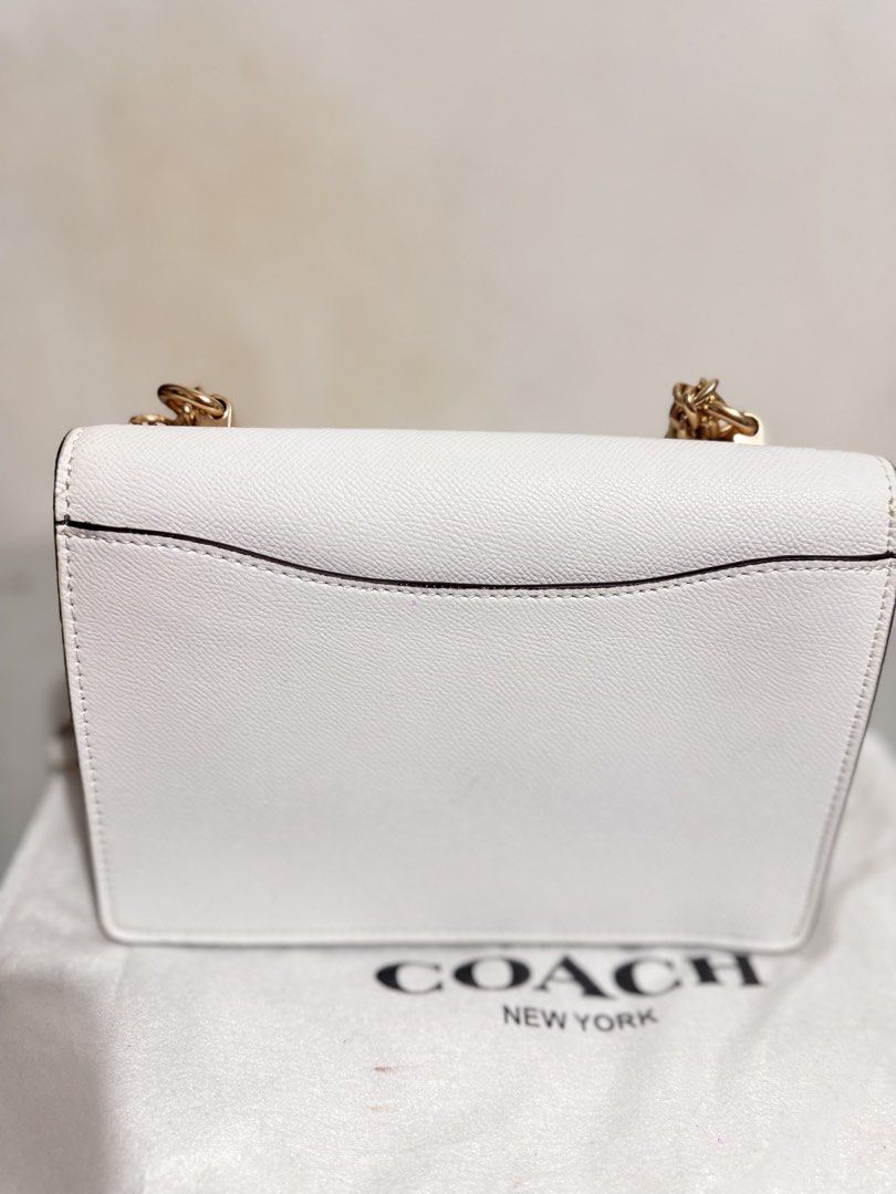 Coach Klare White Chain Crossbody Bag (Category: Luxury Bags & Wallets) located in Mabalacat. Submitted by kay_miscak (Listing ID 1470094020, Image 3). Description: - Coach crossbody bag in pristine condition - Crafted from durable white crossgrain leather with elegant gold hardware - Stylish chain and leather combination strap - Structured accordion design with multiple interior compartments for easy organization - Clean exterior and interior - 