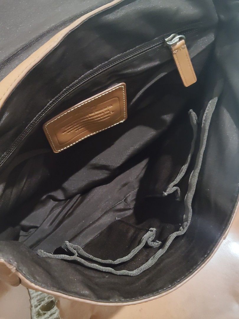 Coach Leather Messenger Bag Brown Blue Strap (Category: Sling Bags) located in Cebu City. Submitted by almzcorner (Listing ID 1469969879, Image 2). Description: - Authentic Coach brown leather messenger bag - Stylish navy and cream webbed strap - Flap closure with secure magnetic snap - Interior features a zipper pocket, slip pockets, and clean fabric lining - Signature leather story patch inside - Silver hardware stamped with the Coach logo - Co