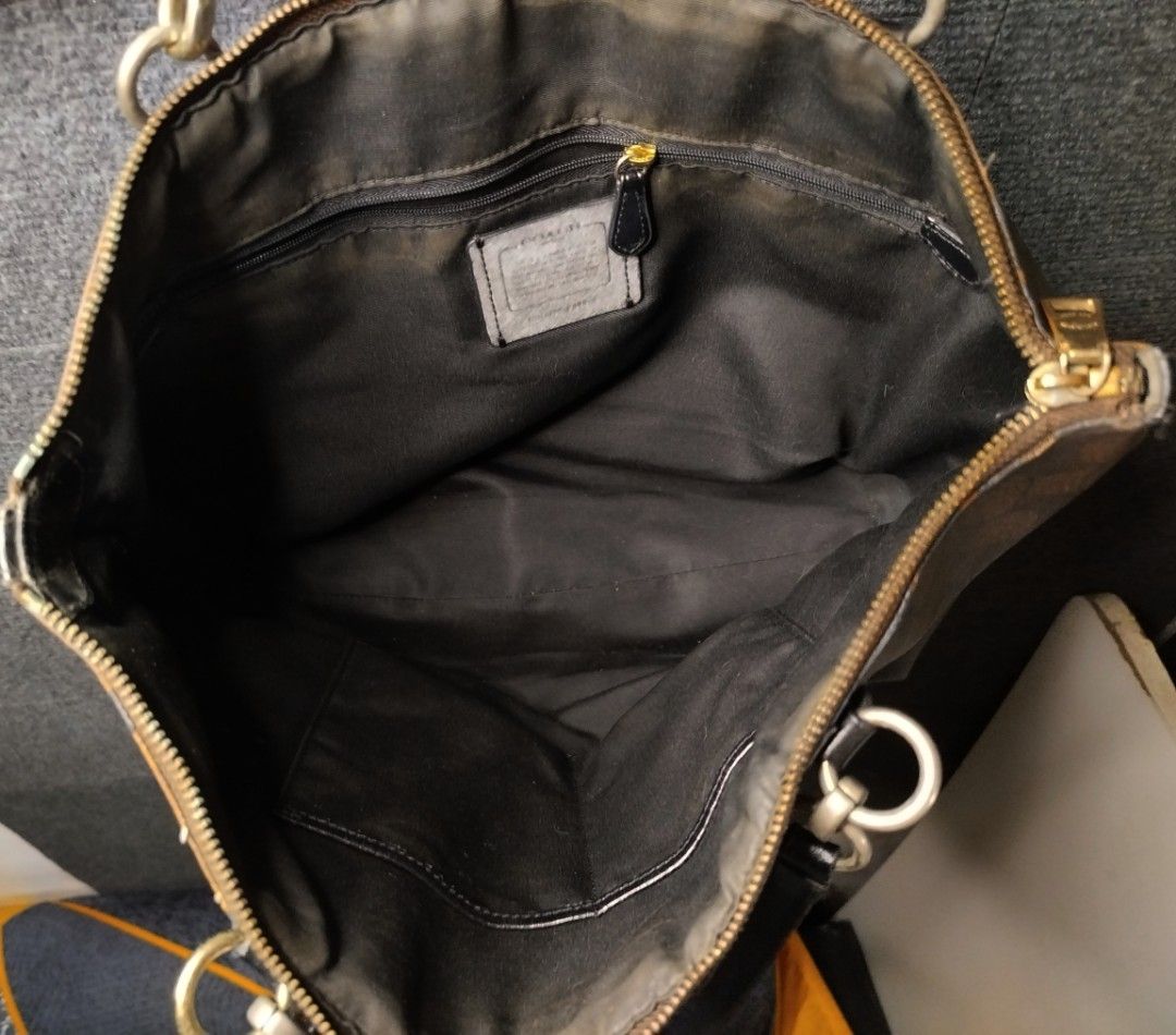 Coach Signature Brown Monogram Tote Bag (Category: Luxury Bags & Wallets) located in Manila. Submitted by luckyfire-b12a (Listing ID 1469998492, Image 3). Description: Coach signature monogram tote bag in dark brown. Classic coated canvas exterior with black leather straps and gold tone hardware. Zip top closure. Inside has fabric lining, one zip pocket, and slip pockets. Interior shows some dust and wear. Strap edges and bottom corners show visi