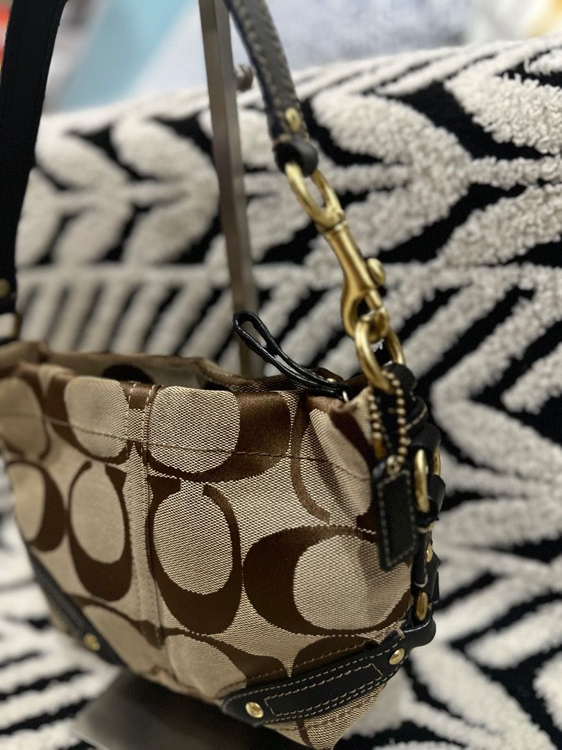 Coach Signature Mini Carly (Category: Luxury Bags & Wallets) located in Cebu City. Submitted by isellhere123.543 (Listing ID 1469983592, Image 3). Description: - Brand: Coach - Material: Signature C jacquard fabric with dark brown leather trim - Color: Brown and beige - Hardware: Brass - Closure: Zip-top - Strap: Single handle - Style: Compact shoulder bag for daily carry - Condition: Clean interior lining.