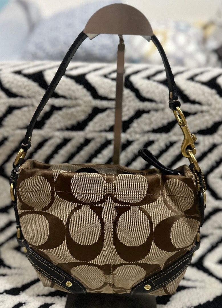 Coach Signature Mini Carly (Category: Luxury Bags & Wallets) located in Cebu City. Submitted by isellhere123.543 (Listing ID 1469983592, Image 1). Description: - Brand: Coach - Material: Signature C jacquard fabric with dark brown leather trim - Color: Brown and beige - Hardware: Brass - Closure: Zip-top - Strap: Single handle - Style: Compact shoulder bag for daily carry - Condition: Clean interior lining.