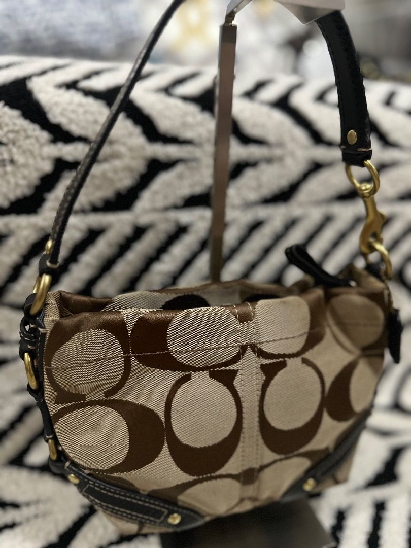 Coach Signature Mini Carly (Category: Luxury Bags & Wallets) located in Cebu City. Submitted by isellhere123.543 (Listing ID 1469983592, Image 2). Description: - Brand: Coach - Material: Signature C jacquard fabric with dark brown leather trim - Color: Brown and beige - Hardware: Brass - Closure: Zip-top - Strap: Single handle - Style: Compact shoulder bag for daily carry - Condition: Clean interior lining.