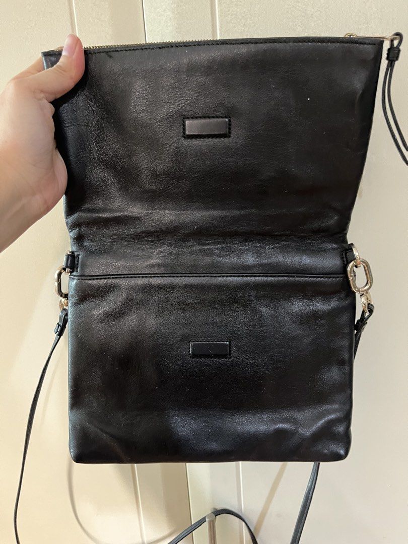 Coach Slim Leather Foldover Crossbody Bag (Category: Luxury Bags & Wallets) located in Makati City. Submitted by sodypop88 (Listing ID 1469953084, Image 2). Description: - Authentic Coach black leather crossbody bag - Features elegant gold-tone hardware and embossed gold carriage logo - Secure foldover flap closure with main zipper compartment - Signature C fabric interior lining with built-in card slots - Comfortable adjustable leather strap - P