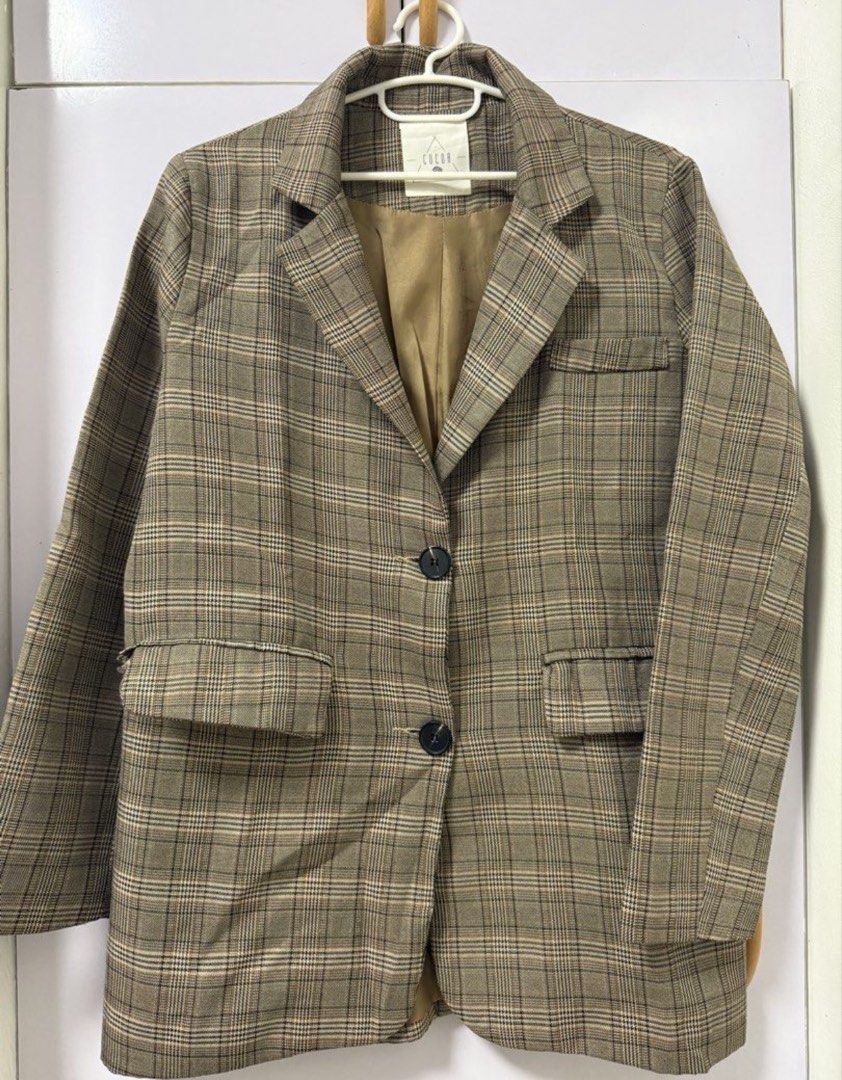 COCOA Brown Plaid Oversized Blazer (Category: Coats, Jackets and Outerwear) located in Quezon City. Submitted by lovedbymaxandmikoy (Listing ID 1470135141, Image 1). Description: - Brand: COCOA (Designed in Korea) - Style: Classic brown plaid/tartan blazer with structured lapels - Closure: Double-button front with matching dark buttons - Pockets: Two front hip flap pockets - Lining: Fully lined in silky bronze fabric - Fit & Use: Great versatile 
