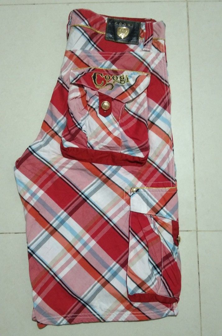 Coogi Red Plaid Cargo Shorts Size W38 (Category: Shorts) located in Manila. Submitted by aj.bermundo (Listing ID 1470025837, Image 1). Description: - Brand: Coogi - Style: Classic streetwear cargo shorts - Pattern & Color: Red plaid - Size: 38 waist - Material: 100% cotton for comfort - Features: Multiple side pockets with button closures and embroidered Coogi logo on the back pocket - Condition: Excellent.