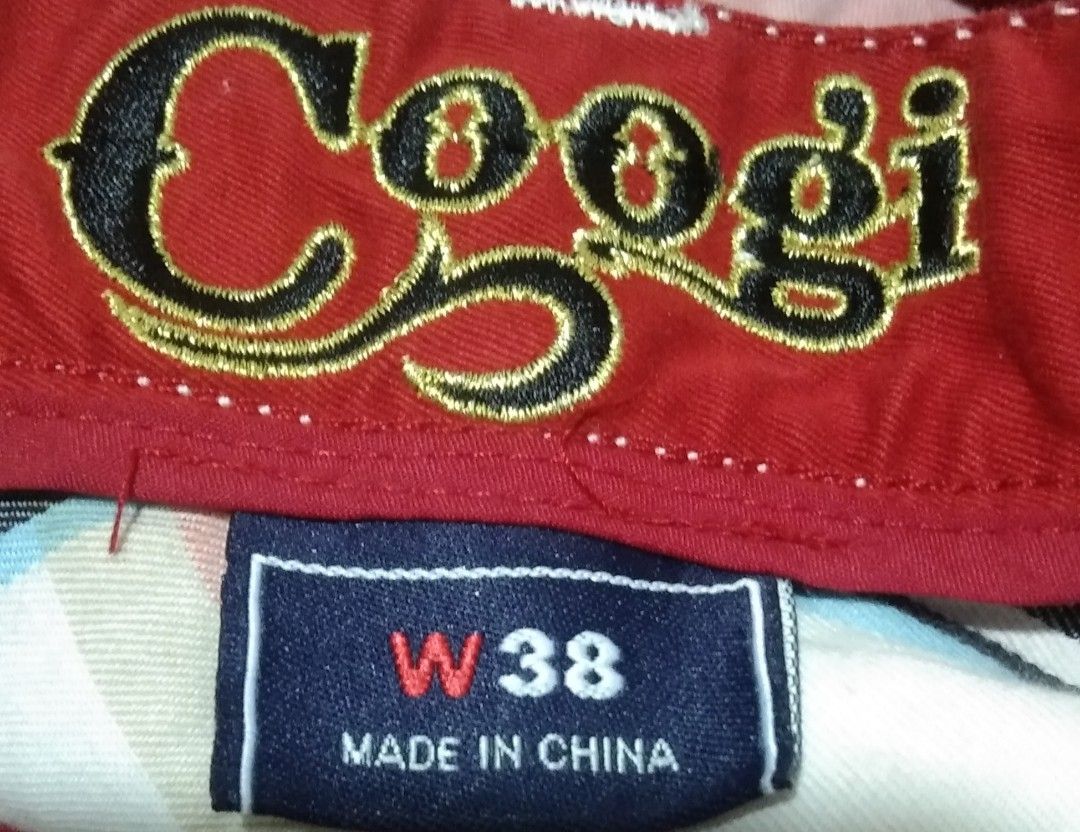 Coogi Red Plaid Cargo Shorts Size W38 (Category: Shorts) located in Manila. Submitted by aj.bermundo (Listing ID 1470025837, Image 3). Description: - Brand: Coogi - Style: Classic streetwear cargo shorts - Pattern & Color: Red plaid - Size: 38 waist - Material: 100% cotton for comfort - Features: Multiple side pockets with button closures and embroidered Coogi logo on the back pocket - Condition: Excellent.
