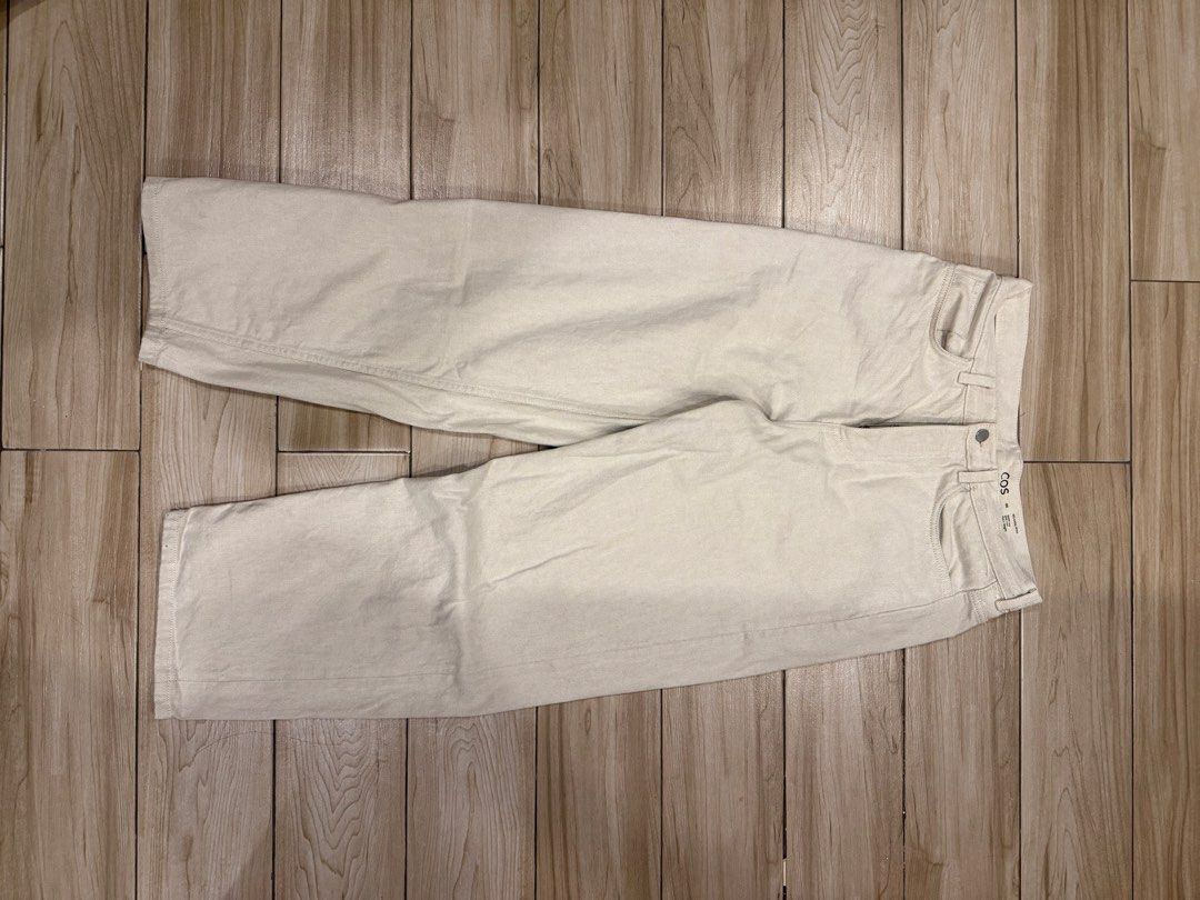 COS Relaxed Wide Leg White Jeans (Category: Jeans) located in Santa Rosa. Submitted by jericobngo (Listing ID 1469950776, Image 1). Description: - Brand: COS - Style: Relaxed wide-leg pants, mid-rise, full length - Color: Off-white / Light beige - Size: 46 (as labeled on waistband), fits waist 30-32 - Details: Sturdy denim-like twill fabric, two back patch pockets, interior QR code care tag .