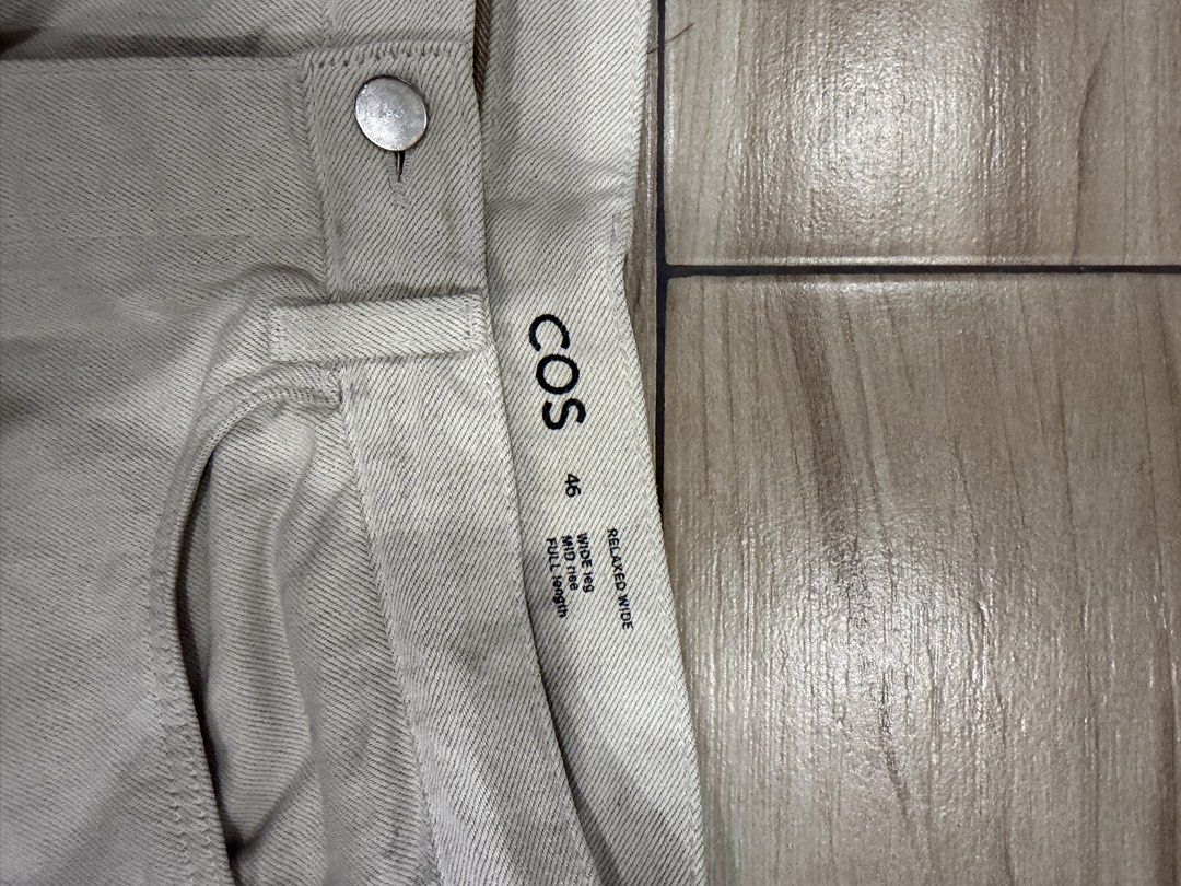 COS Relaxed Wide Leg White Jeans (Category: Jeans) located in Santa Rosa. Submitted by jericobngo (Listing ID 1469950776, Image 2). Description: - Brand: COS - Style: Relaxed wide-leg pants, mid-rise, full length - Color: Off-white / Light beige - Size: 46 (as labeled on waistband), fits waist 30-32 - Details: Sturdy denim-like twill fabric, two back patch pockets, interior QR code care tag .
