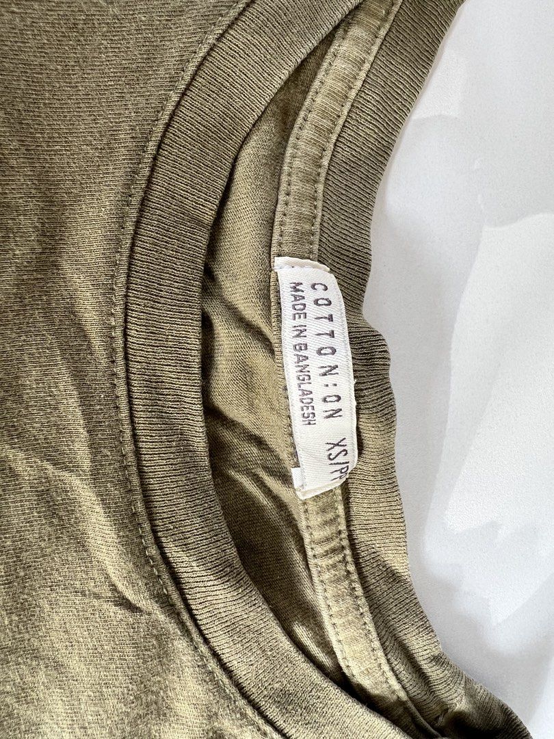 COTTON ON Basic The Baby Tees 2 PCS (Category: Shirts) located in Santiago. Submitted by riceavllnz (Listing ID 1469958961, Image 2). Description: Get these 2 Simple everyday essentials from Cotton On, in neutral beige and olive green. * Brand: Cotton On * Size: XS/P (as shown on the tags) * Colors: Beige and olive green * Made in: Bangladesh * Condition: Preloved Perfect for casual outfits, layering, and everyday wear. Easy to pair with jeans, s