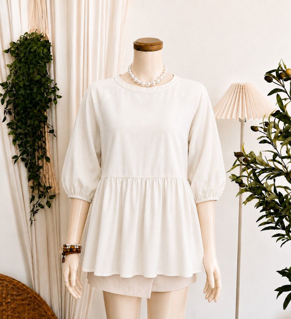 Cream Peplum Blouse with Half Sleeves (Category: Blouses) located in Cebu City. Submitted by smnthdanielle (Listing ID 1470128536, Image 1). Description: - Color: Cream - Style: Peplum with flared waist and gathered detailing - Neckline: Round neckline - Sleeves: Half raglan sleeves with gathered elastic cuffs - Fabric: Soft and comfortable - Versatility: Neutral shade that pairs easily with skirts and pants.