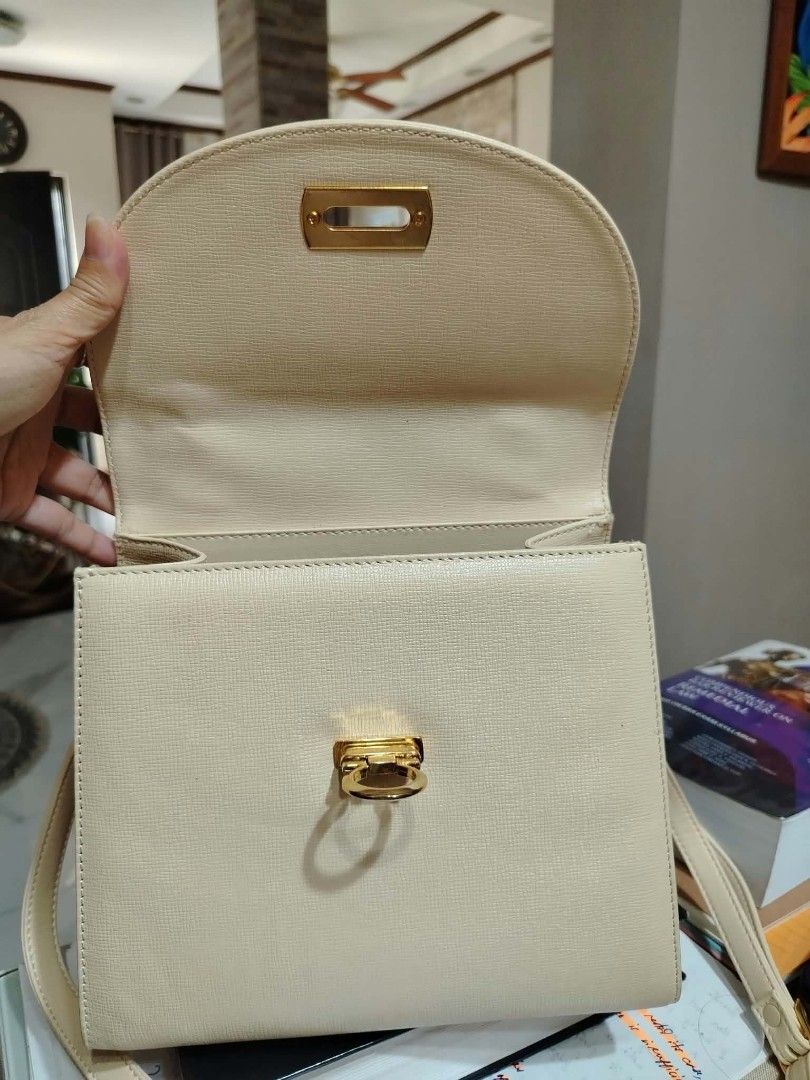 Cream Top Handle Bag With Detachable Strap (Category: Shoulder Bags) located in Paranaque City. Submitted by yensfashionfinds (Listing ID 1469974033, Image 3). Description: - Color: Versatile cream (matches any daily outfit) - Material: Genuine leather with premium gold-tone hardware - Closure: Unique front flap lock closure - Straps: Includes a sturdy top handle and a long, adjustable shoulder strap with buckle detail - Interior: Clean, lined in