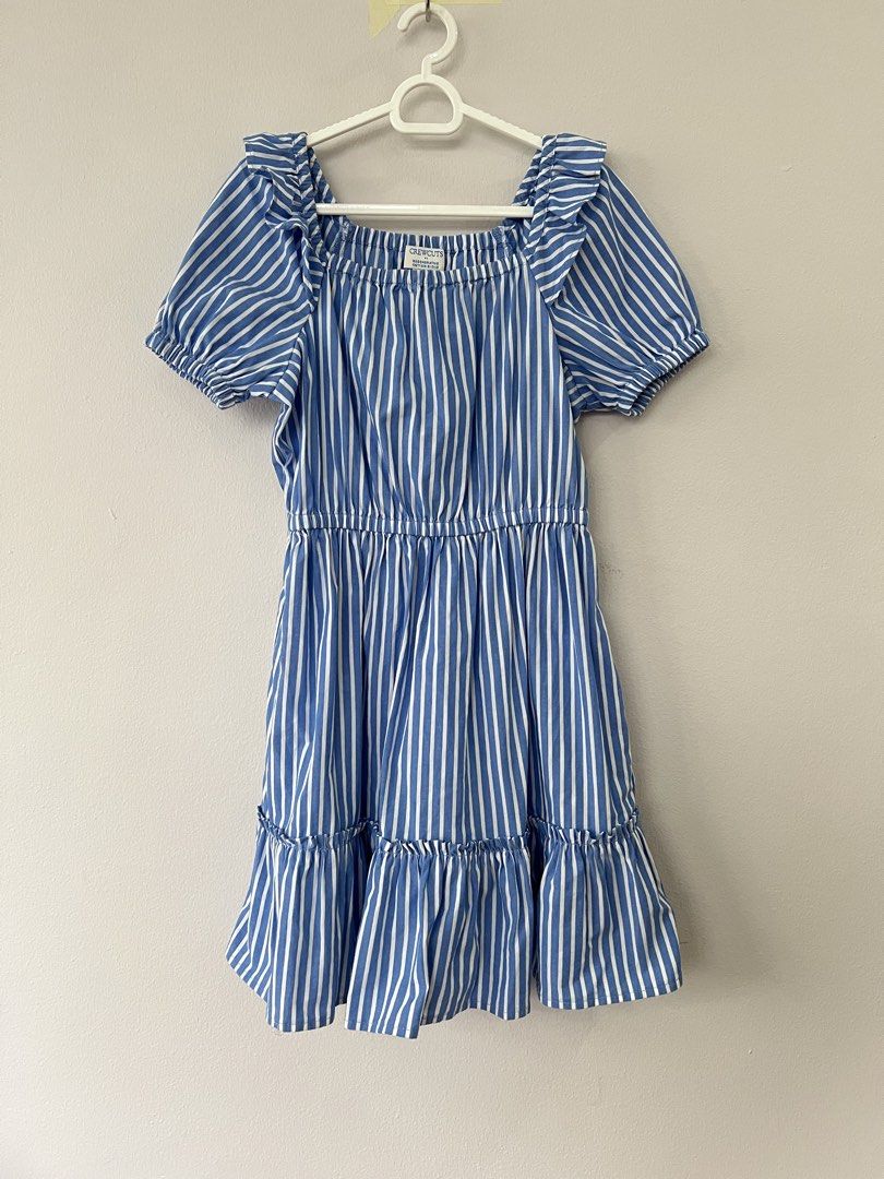 Crewcuts Blue White Striped Ruffle Dress (Category: Babies & Kids Fashion) located in San Fernando. Submitted by wearvfs (Listing ID 1470003601, Image 1). Description: - Brand: Crewcuts - Size: 6 - Design: Blue and white stripes with square neckline, ruffle sleeve trim, and tiered skirt - Material: cotton blend - Comfort: Elastic waist for easy, everyday wear - Measurements: Length ~68 cm, Waist width ~32 cm (stretches in the waist).