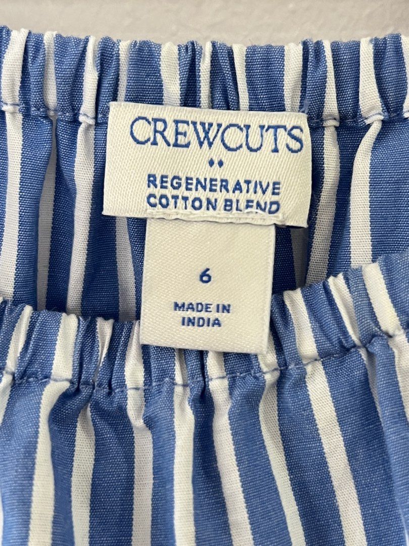 Crewcuts Blue White Striped Ruffle Dress (Category: Babies & Kids Fashion) located in San Fernando. Submitted by wearvfs (Listing ID 1470003601, Image 2). Description: - Brand: Crewcuts - Size: 6 - Design: Blue and white stripes with square neckline, ruffle sleeve trim, and tiered skirt - Material: cotton blend - Comfort: Elastic waist for easy, everyday wear - Measurements: Length ~68 cm, Waist width ~32 cm (stretches in the waist).