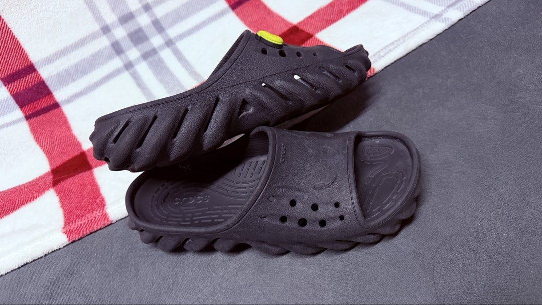 Crocs Echo Slide Black with Jibbitz M5/W7 (Category: Slippers and slides) located in Cavite. Submitted by rhea0218 (Listing ID 1470031341, Image 2). Description: - Item: Black Crocs Echo Slides - Style: Futuristic chunky sculpted sole design - Inclusions: Two Jibbitz charms (small pink text charm and light blue block charm) - Condition: Pre-owned with light wear on tread and footbed, clean overall shape - Type: Slip-on casual footwear.