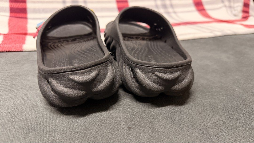 Crocs Echo Slide Black with Jibbitz M5/W7 (Category: Slippers and slides) located in Cavite. Submitted by rhea0218 (Listing ID 1470031341, Image 3). Description: - Item: Black Crocs Echo Slides - Style: Futuristic chunky sculpted sole design - Inclusions: Two Jibbitz charms (small pink text charm and light blue block charm) - Condition: Pre-owned with light wear on tread and footbed, clean overall shape - Type: Slip-on casual footwear.