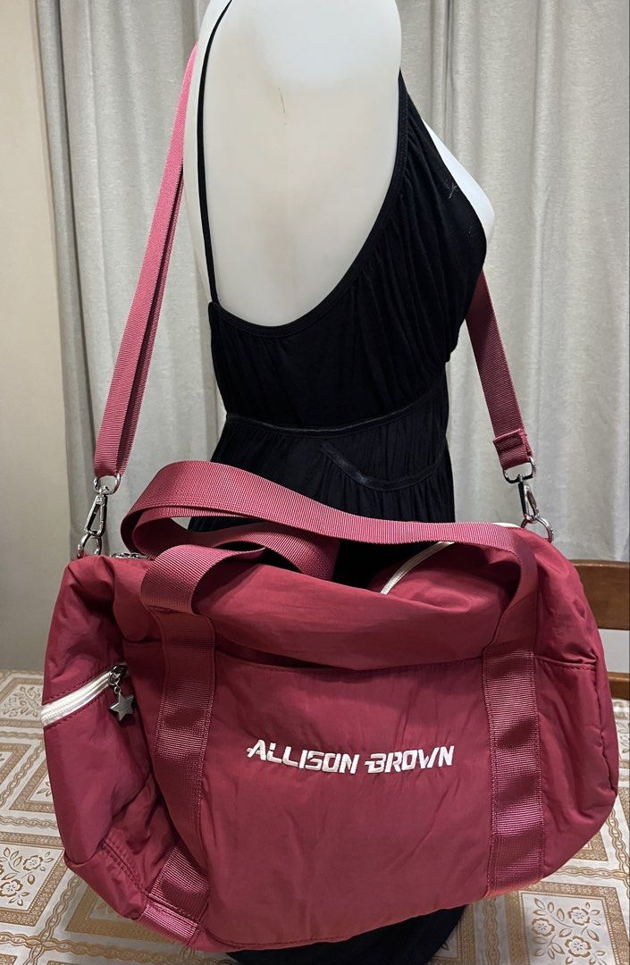 Crossbody bag (Category: Cross-body Bags) located in Bacoor. Submitted by ayit. (Listing ID 1470067986, Image 3). Description: Orig japan glinf sf inc s nego - Brand/Model: Allison Brown Crossbody/Duffel Bag - Color: Maroon with white zipper and white embroidered branding - Material: Durable nylon/fabric material - Versatile carry options: Dual hand straps and an adjustable, removable long shoulder strap - Features: Spacious main compartment, fro