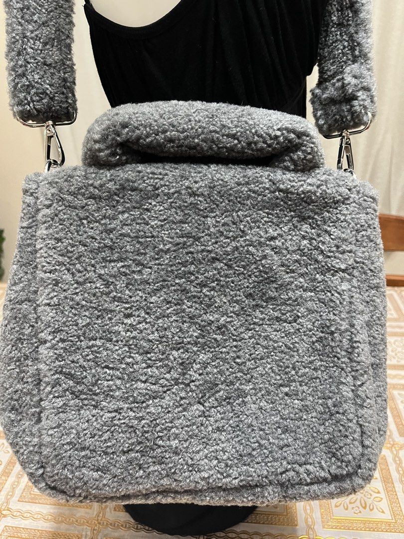 Crossbody/top handle bag (Category: Cross-body Bags) located in Bacoor. Submitted by ayit. (Listing ID 1470059981, Image 3). Description: Bnew orig japan gling sf inc - Brand: Allison Brown - Color: Dark grey with pink embroidery and heart detail - Material: Soft fuzzy fleece / sherpa fabric - Style: Crossbody or top handle bag with matching plush strap - Condition: Excellent, well-maintained.