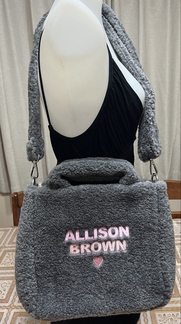 Crossbody/top handle bag (Category: Cross-body Bags) located in Bacoor. Submitted by ayit. (Listing ID 1470059981, Image 1). Description: Bnew orig japan gling sf inc - Brand: Allison Brown - Color: Dark grey with pink embroidery and heart detail - Material: Soft fuzzy fleece / sherpa fabric - Style: Crossbody or top handle bag with matching plush strap - Condition: Excellent, well-maintained.