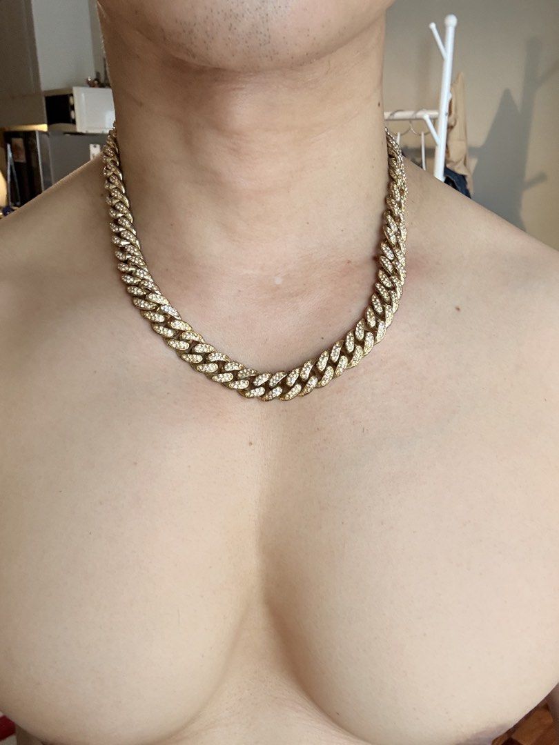 Cuban Iced-Out Chain Necklace (Category: Jewelry) located in Mandaluyong City. Submitted by material_boi (Listing ID 1469996426, Image 2). Description: Nice accessory if you love adornments. Bought this for ₱2K I think for a costume party. Gold then may stones siya, i don’t know what stones are these. Di masagwa ang pagka-gold nya. Double lock. Mabigat. 20 inches long when laid flat. Issues: tarnished na yung likod, pero yung harap na may stones 