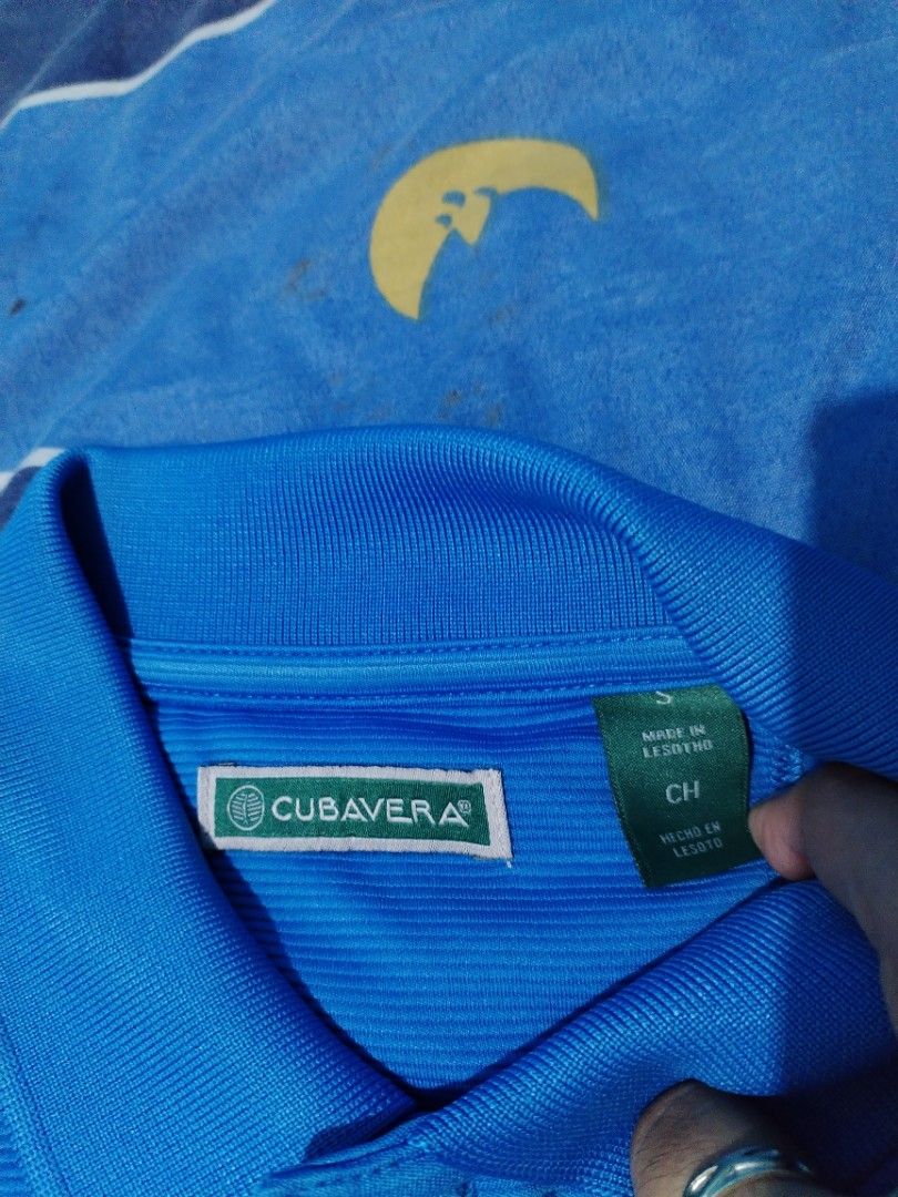 Cubavera Blue Polo Shirt Size S (Category: Tshirts & Polo Shirts ) located in Manila. Submitted by solebrothers2826 (Listing ID 1470103203, Image 2). Description: - Brand: Cubavera - Color: Blue with all-over textured fabric - Size: Small (S) - Pit to Pit: ~19 to 20 inches - Length: ~26 inches - Details: Short sleeves, standard collar, 3-button placket - Origin: Made in Lesotho - Condition: Clean and ready to wear Yung last pic, sample pricing ng