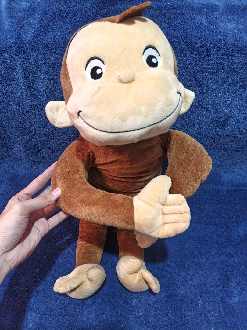 Curious George plush toy stuffed monkey (Category: Plushies & Soft Toys) located in Manila. Submitted by kirstentoyshub (Listing ID 1470011616, Image 2). Description: - Adorable brown stuffed monkey plush toy - Features a soft fabric body, big round eyes, and a friendly smile - Cream-colored face, ears, hands, and feet - Classic character design inspired by beloved books and shows - Clean and well-maintained condition, ready for its new home.