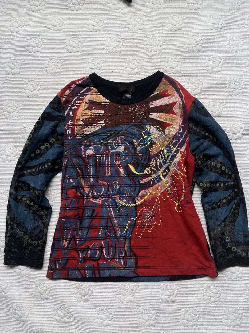 Custo Barcelona long sleeve graphic top (Category: Longsleeves) located in Alabel. Submitted by geragarhea13830 (Listing ID 1470090688, Image 1). Description: - Brand: Custo Barcelona - Era: Y2K vintage statement piece - Fit: Fitted cut with a classic crew neckline - Front Details: Vibrant red, black, and blue colorway with heavy graphic prints, embroidery, and stud embellishments - Back Details: Large abstract floral pattern in shades of blue an