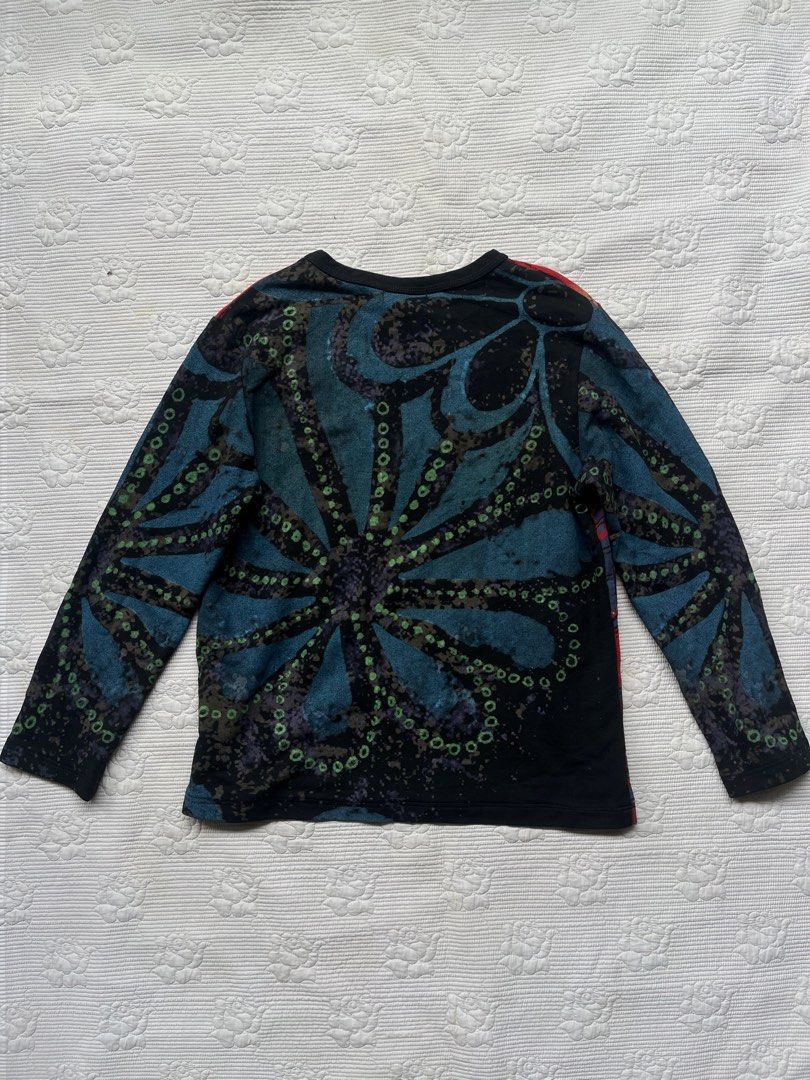 Custo Barcelona long sleeve graphic top (Category: Longsleeves) located in Alabel. Submitted by geragarhea13830 (Listing ID 1470090688, Image 2). Description: - Brand: Custo Barcelona - Era: Y2K vintage statement piece - Fit: Fitted cut with a classic crew neckline - Front Details: Vibrant red, black, and blue colorway with heavy graphic prints, embroidery, and stud embellishments - Back Details: Large abstract floral pattern in shades of blue an