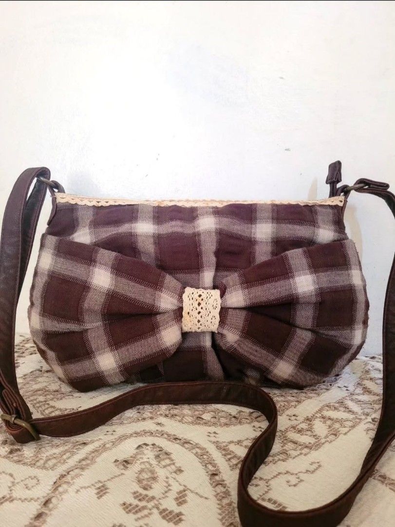 Cute Brown Bow Checked Sling Bag (Category: Cross-body Bags) located in Balanga. Submitted by marae_c (Listing ID 1470085410, Image 1). Description: In very good condition. Few brown stains and little rub sa may sling. See last pic for ref. Other than that all goods and quite spacoius for its size. Perfect bag for mori kei, academia and cottage vibes as well. To edit. Measurements..