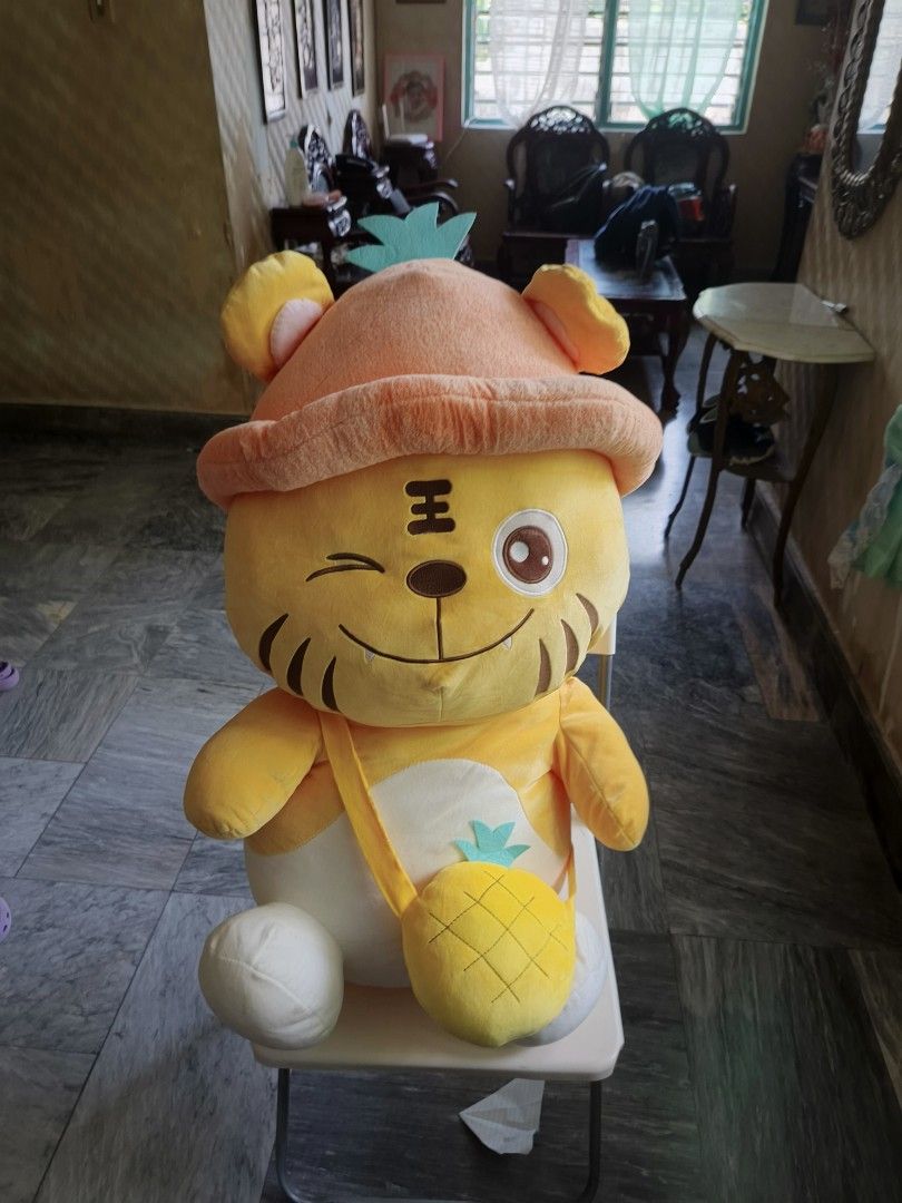 Cute Tiger Plush Toy with Pineapple Bag and Hat (Category: Plushies & Soft Toys) located in Iligan City. Submitted by sneakymagician (Listing ID 1469983645, Image 2). Description: Super soft and fluffy yellow tiger plush wearing a cute orange fruit hat and matching pineapple crossbody bag. Features a playful winking face and bright colors. In a sitting pose and in excellent, clean condition. won this @ Dapitan Fantasy Land SUPER BIG.