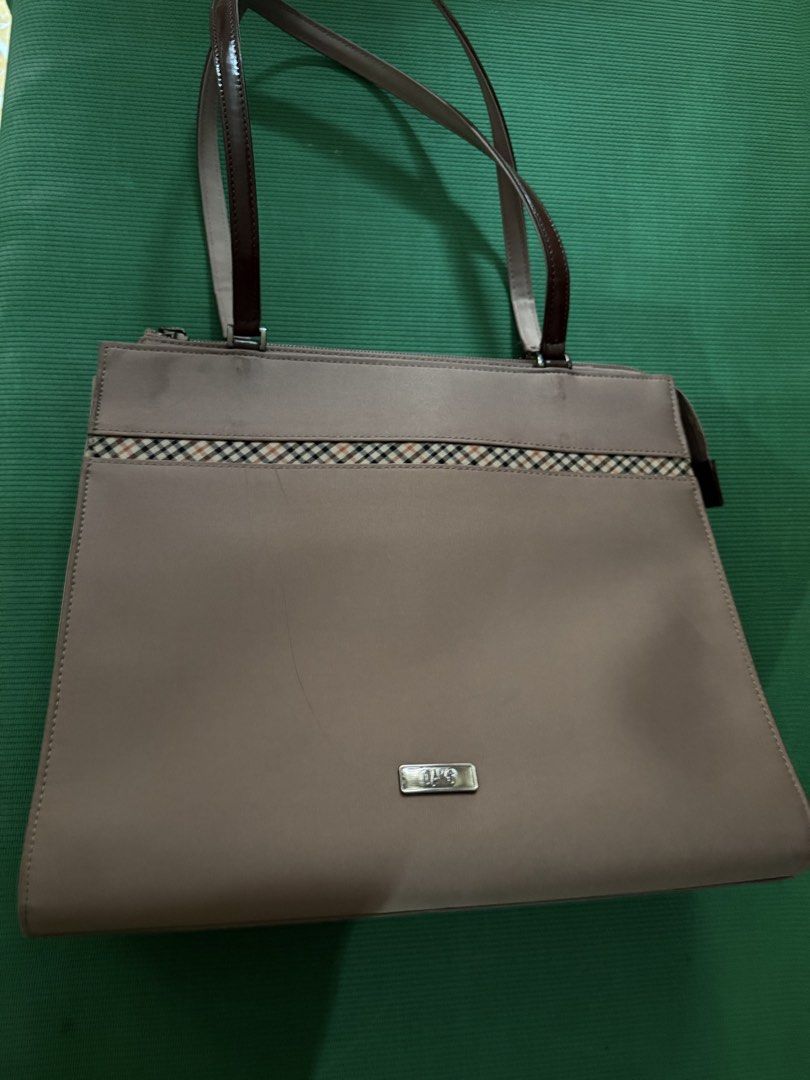 DAKS Beige Shoulder Bag with Plaid Accent (Category: Shoulder Bags) located in Makati City. Submitted by goodfindsonly (Listing ID 1470139151, Image 1). Description: - Brand: DAKS - Color: Muted beige with classic plaid strip and dark brown straps - Hardware: Silver-tone with metal DAKS logo plate - Closure: Secure top zipper closure - Compartments: Lined interior with multiple slip pockets + exterior back zip pocket - Condition: Clean lines and 
