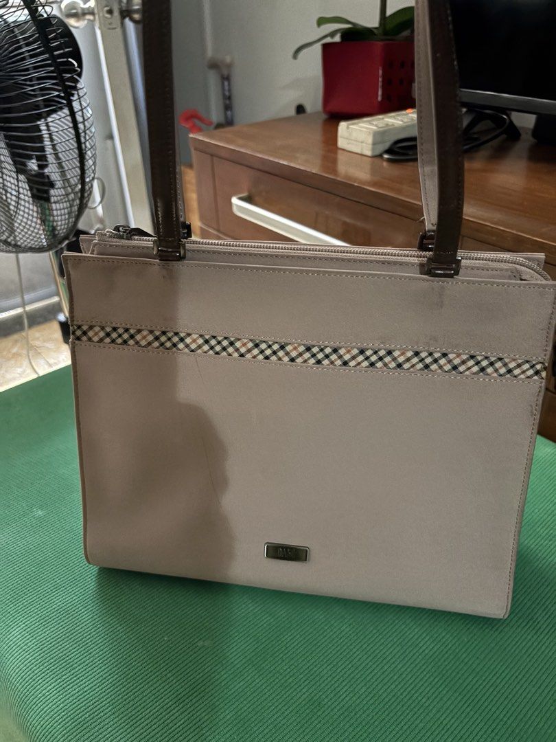 DAKS Beige Shoulder Bag with Plaid Accent (Category: Shoulder Bags) located in Makati City. Submitted by goodfindsonly (Listing ID 1470139151, Image 2). Description: - Brand: DAKS - Color: Muted beige with classic plaid strip and dark brown straps - Hardware: Silver-tone with metal DAKS logo plate - Closure: Secure top zipper closure - Compartments: Lined interior with multiple slip pockets + exterior back zip pocket - Condition: Clean lines and 
